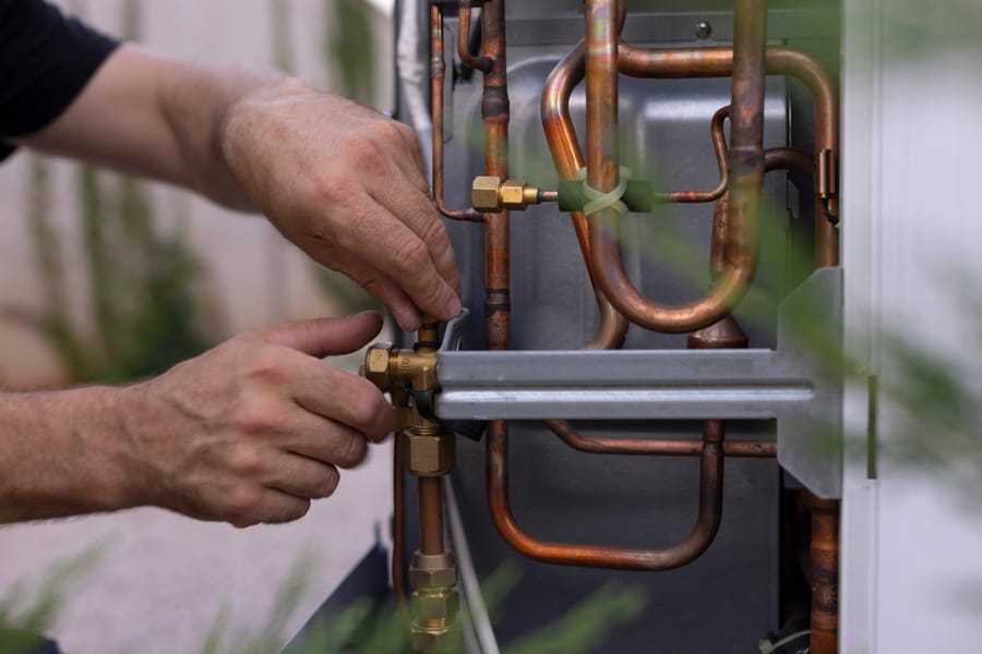 Close-up shot of a technician installing a heat pump stock photo