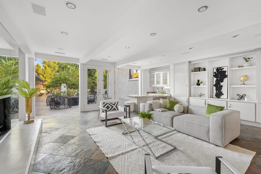 A clean living room with white ceiling and white walls.